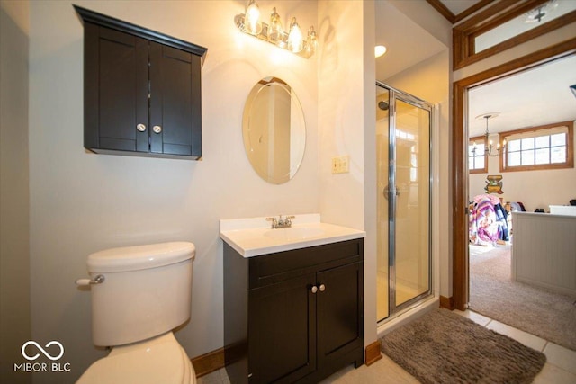 bathroom with toilet, a shower stall, and vanity