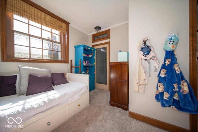 bedroom featuring ornamental molding, light carpet, and baseboards