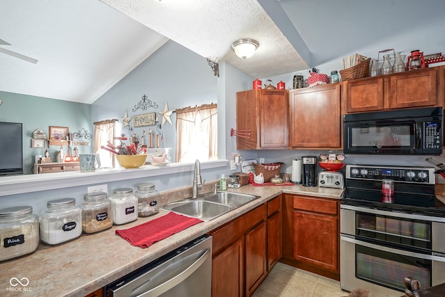 kitchen with light countertops, lofted ceiling, brown cabinetry, stainless steel appliances, and a sink