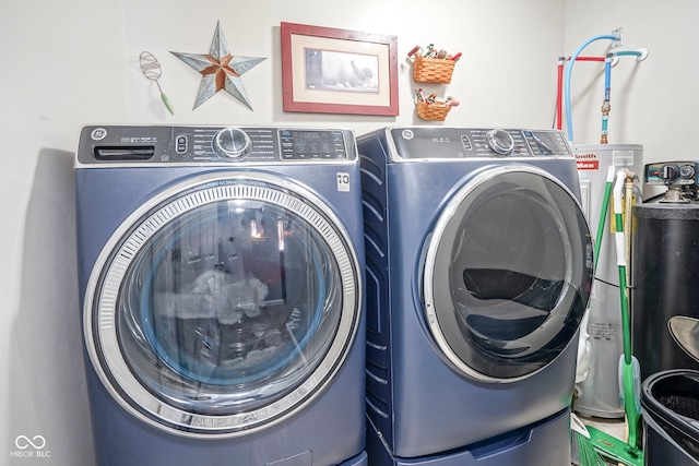 clothes washing area featuring washer and dryer and laundry area