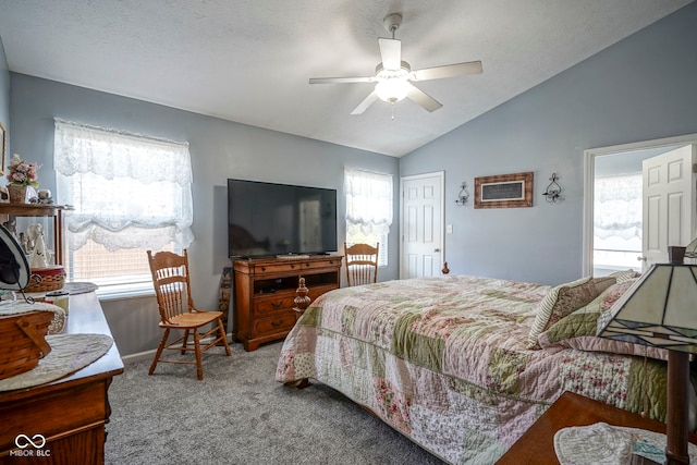 bedroom featuring multiple windows, a ceiling fan, lofted ceiling, and carpet floors