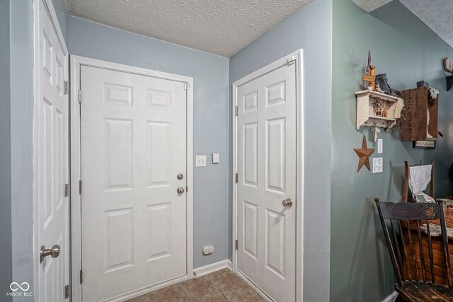 interior space featuring baseboards and a textured ceiling