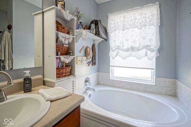 bathroom featuring a garden tub and vanity