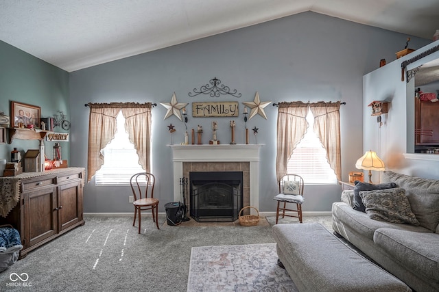 living room with baseboards, lofted ceiling, a fireplace, and carpet flooring