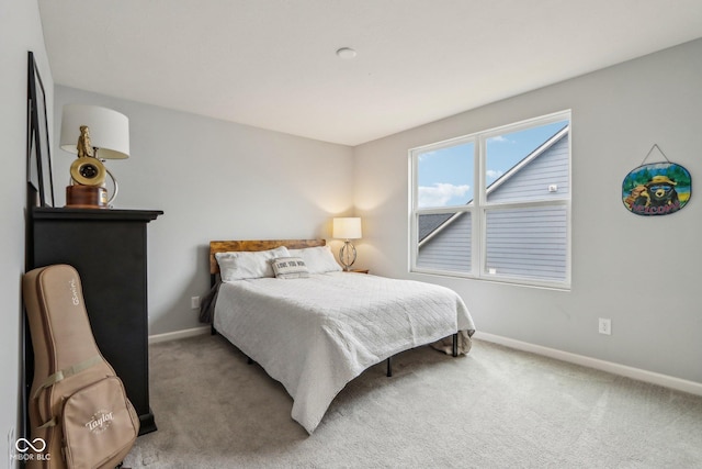 bedroom with carpet floors and baseboards