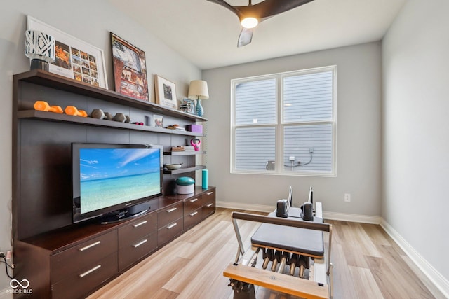 office space with light wood-style flooring, baseboards, and ceiling fan