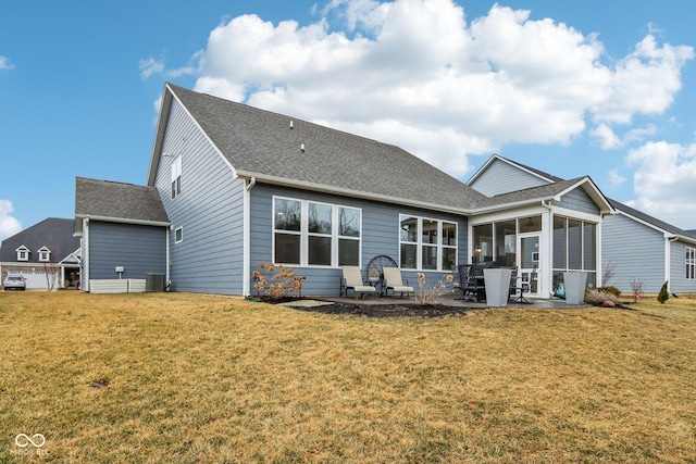 back of property featuring a patio, roof with shingles, a lawn, and a sunroom