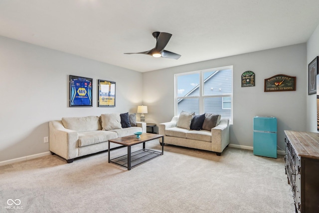 living room with light carpet, ceiling fan, and baseboards