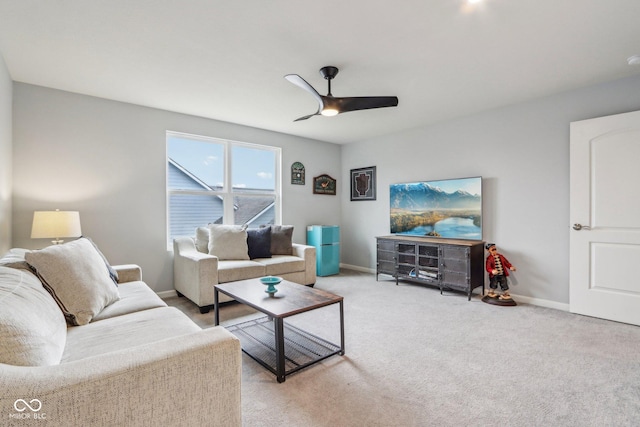 carpeted living room featuring ceiling fan and baseboards