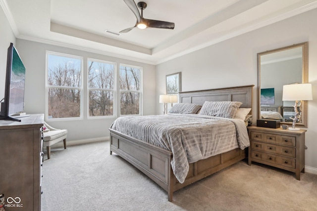 bedroom with light carpet, ornamental molding, a raised ceiling, and visible vents