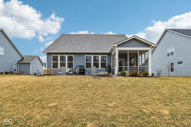 back of property featuring a sunroom and a yard