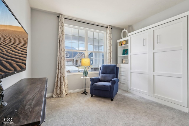 living area featuring carpet floors and baseboards