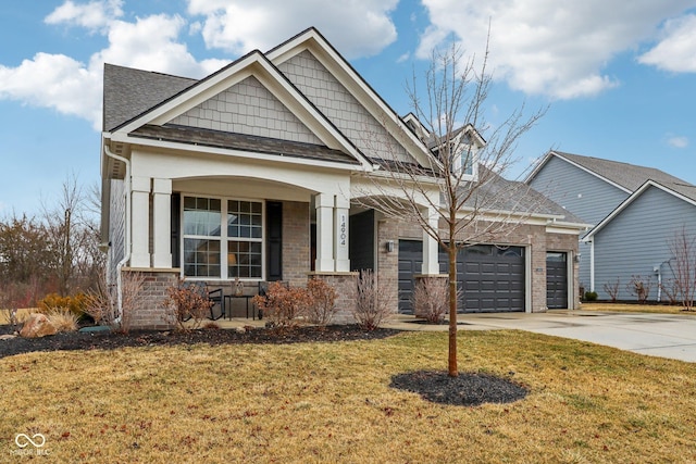 craftsman-style house featuring a garage, concrete driveway, a front yard, a porch, and brick siding