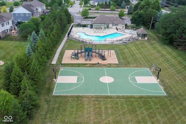 view of sport court with a yard, playground community, and community basketball court