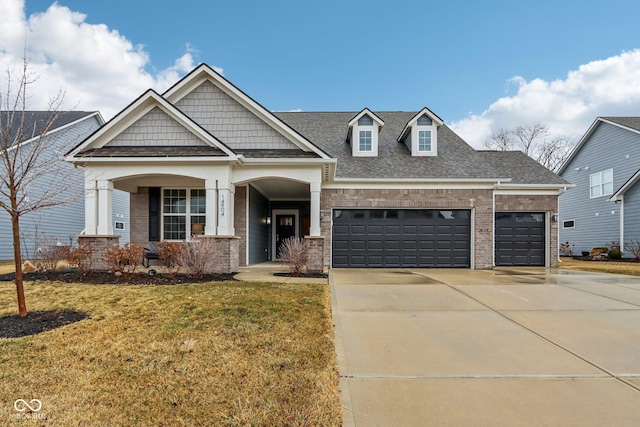 craftsman inspired home with an attached garage, brick siding, concrete driveway, roof with shingles, and a front yard