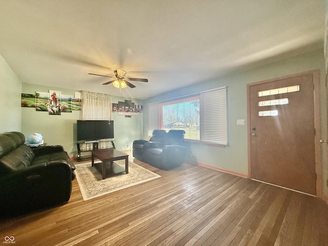 living room with baseboards, ceiling fan, and hardwood / wood-style floors