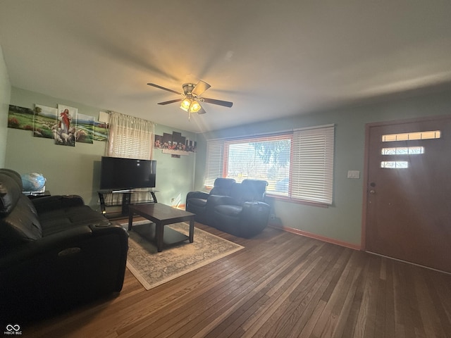 living area featuring ceiling fan, hardwood / wood-style flooring, and baseboards