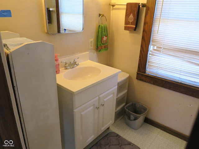 bathroom featuring tile patterned floors, baseboards, and vanity