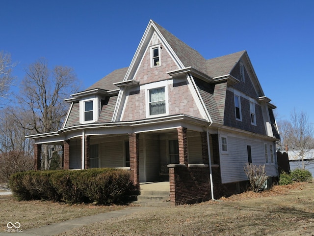 view of front of property featuring covered porch and brick siding