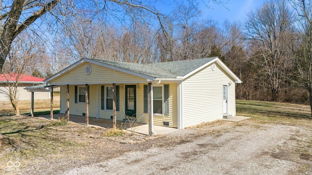 view of front of home featuring crawl space, a porch, and roof with shingles