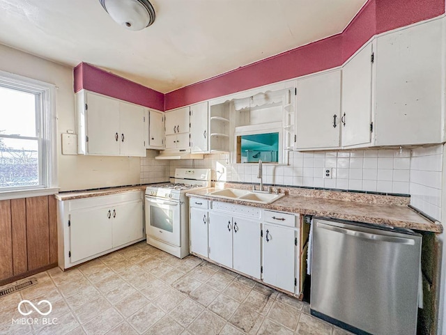 kitchen with white range with gas stovetop, white cabinetry, and stainless steel dishwasher