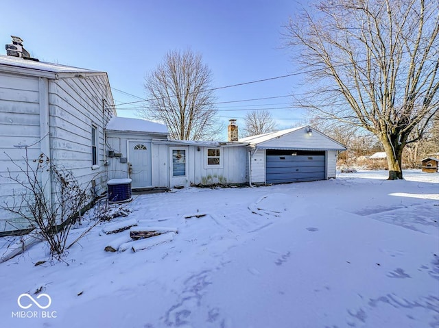 exterior space featuring a chimney, central AC unit, and board and batten siding