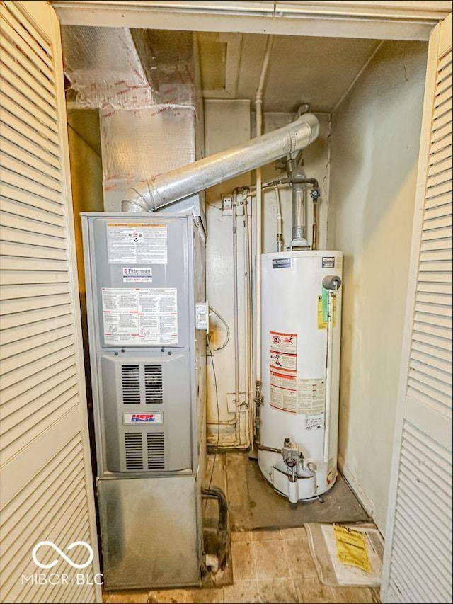 utility room featuring heating unit and water heater