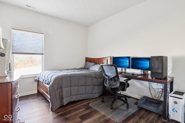 bedroom with baseboards, visible vents, and dark wood-style flooring