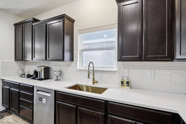 kitchen with dishwasher, light countertops, tasteful backsplash, and a sink