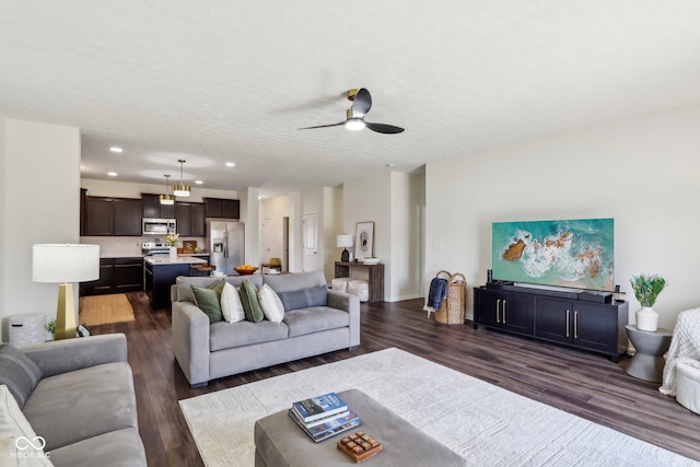 living area with dark wood-style floors, a textured ceiling, a ceiling fan, and recessed lighting