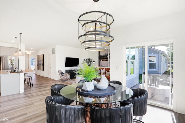 dining room with light wood finished floors, visible vents, a chandelier, and recessed lighting