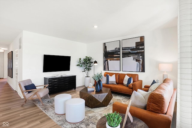 living area with wood finished floors and recessed lighting