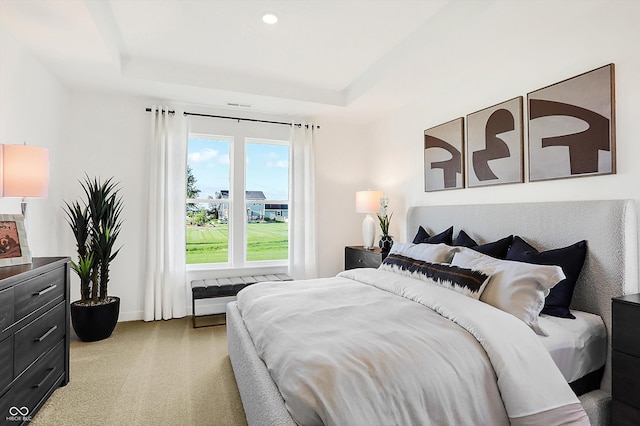 bedroom featuring light carpet, baseboards, a tray ceiling, and recessed lighting