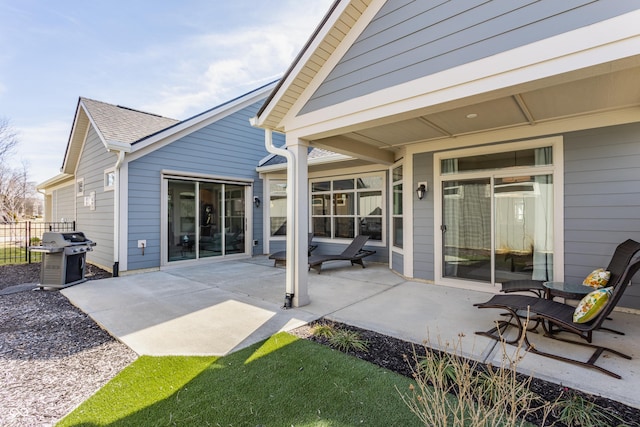 view of patio with area for grilling and fence