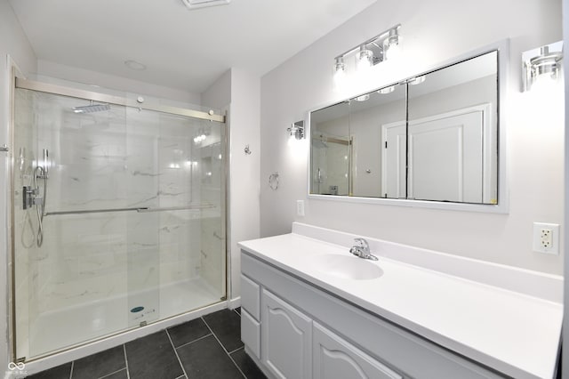 bathroom featuring a shower stall, tile patterned flooring, and vanity