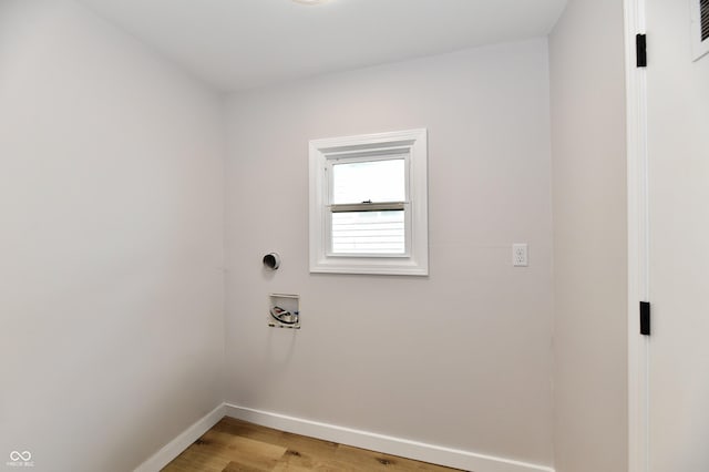 washroom featuring washer hookup, laundry area, light wood finished floors, and baseboards