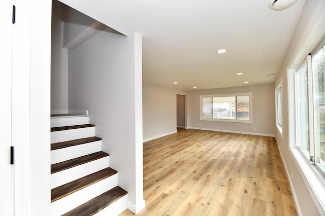 interior space featuring baseboards, wood finished floors, and recessed lighting