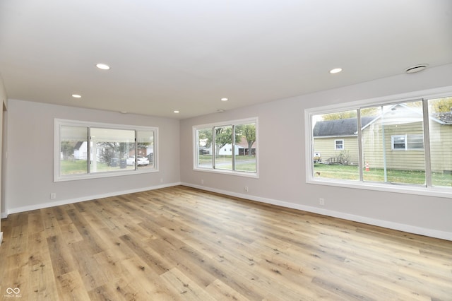 spare room with recessed lighting, light wood-style flooring, and baseboards