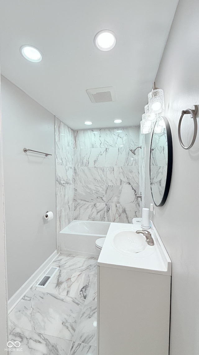 bathroom with marble finish floor, visible vents, tub / shower combination, and vanity