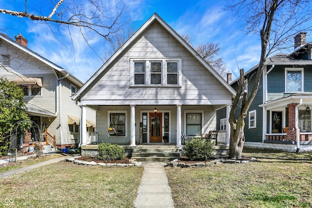 view of front of house with a porch and a front lawn