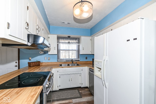 kitchen with visible vents, appliances with stainless steel finishes, a sink, and wood counters