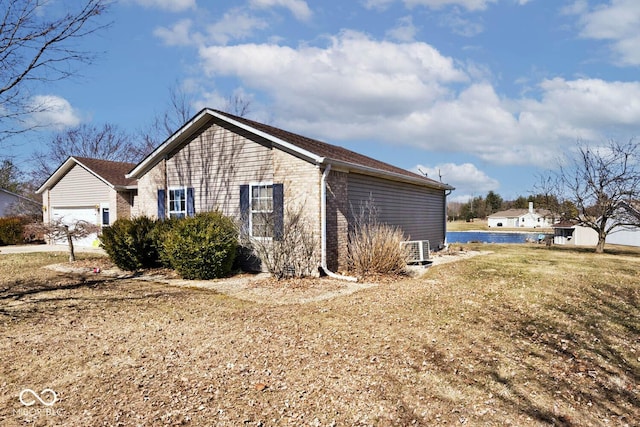 view of property exterior with an attached garage and brick siding