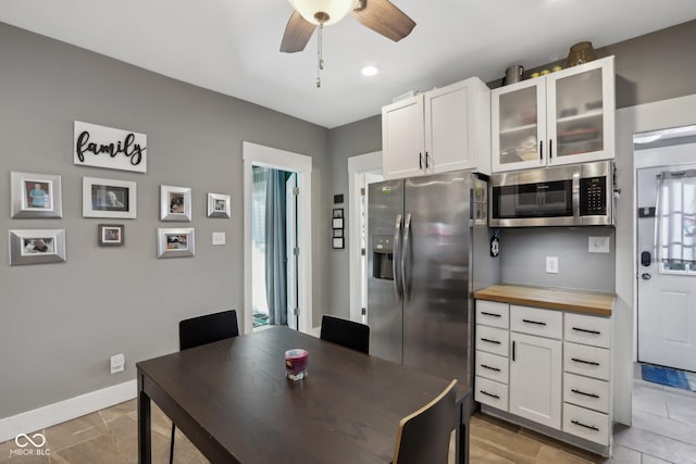 1413 S E St, Indianapolis, IN 46225 - dining space featuring light tile patterned flooring, baseboards, and ceiling fan