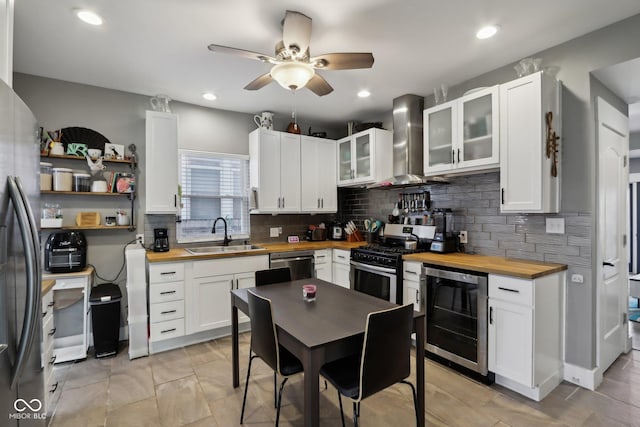 1413 S E St, Indianapolis, IN 46225 - kitchen featuring wooden counters, wall chimney range hood, wine cooler, stainless steel appliances, and a sink