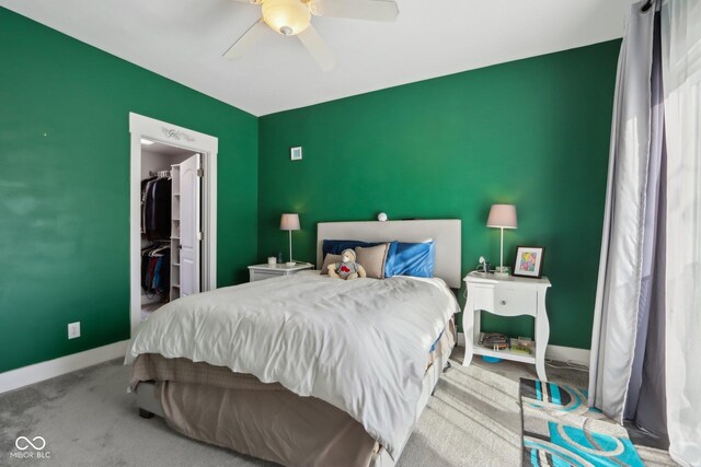 1413 S E St, Indianapolis, IN 46225 - bedroom featuring a walk in closet, baseboards, carpet, and an accent wall