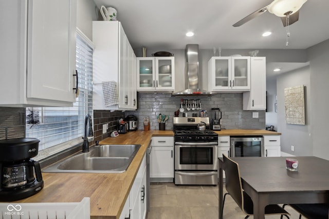 1413 S E St, Indianapolis, IN 46225 - kitchen featuring wooden counters, wall chimney range hood, wine cooler, stainless steel gas range, and a sink