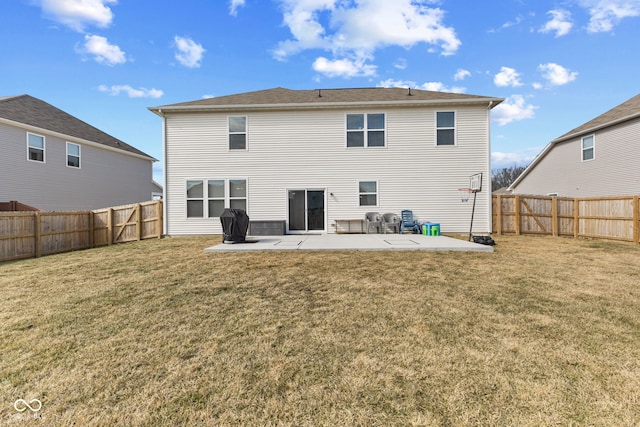 rear view of house with a patio area, a lawn, and a fenced backyard