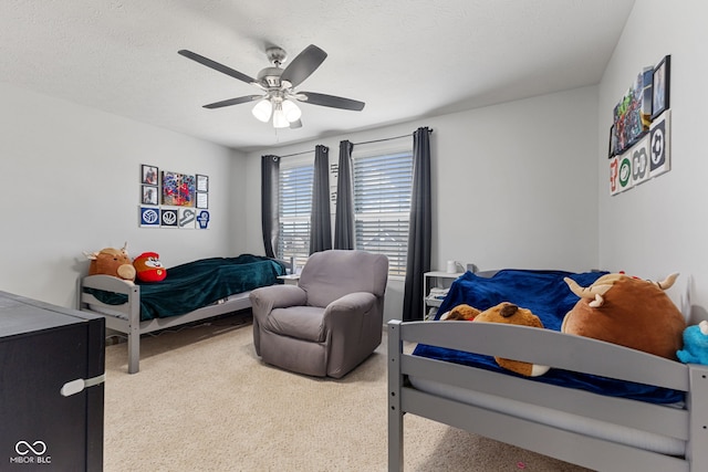 bedroom featuring ceiling fan and a textured ceiling