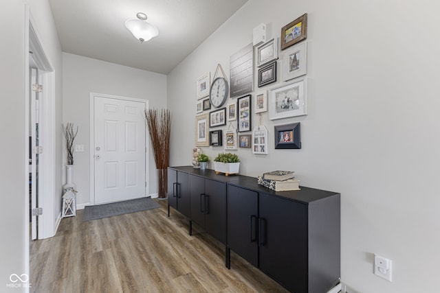 foyer with wood finished floors and baseboards