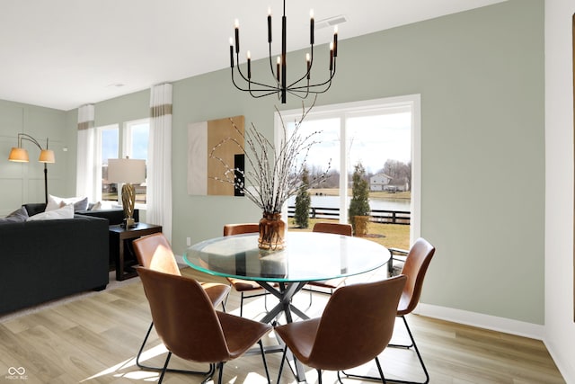 dining area featuring light wood-style flooring and baseboards